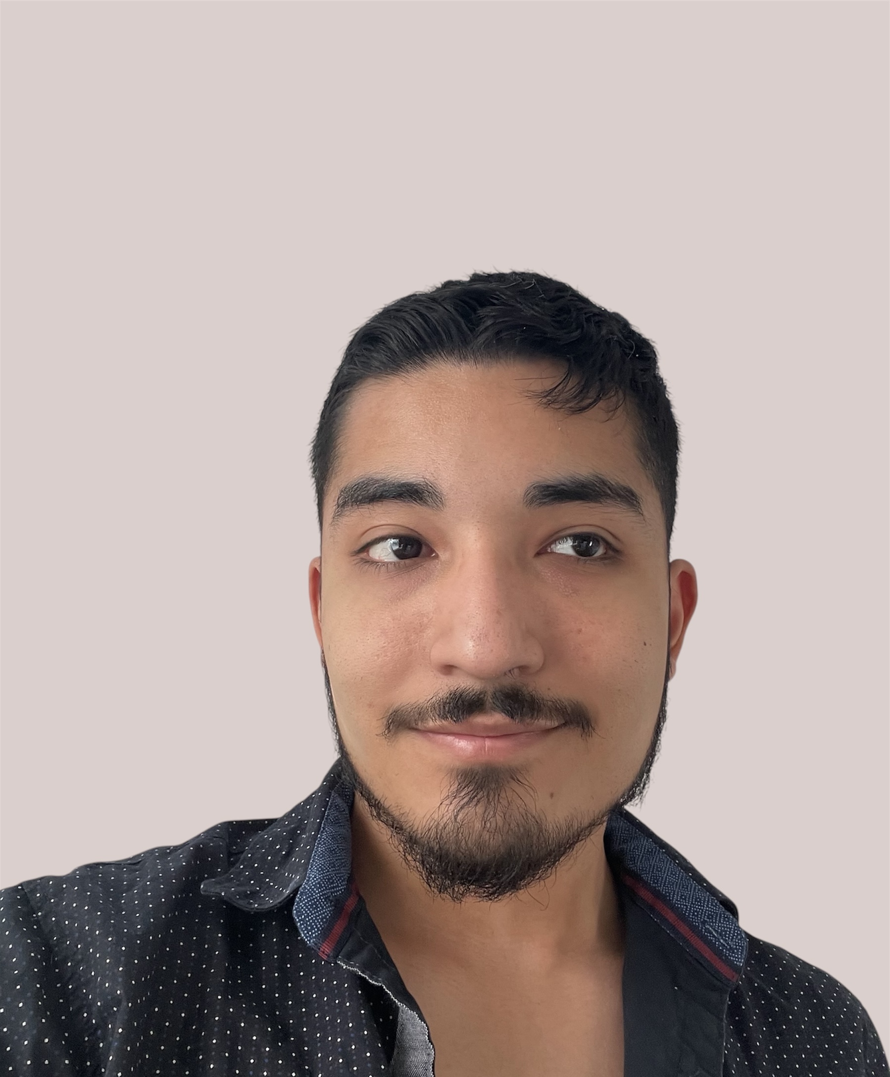 Portrait of Angel Lopez with a beige background.